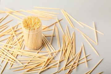 Holder with wooden toothpicks on white background