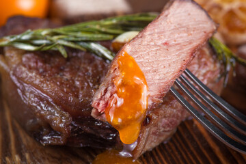 Grilled marbled beef steak. Grilled beef tenderloin steak or beef grits steak on a board. View from...