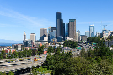 Fototapeta na wymiar Cityscape view of the Seattle skyline with Interstate 5 on a sunny summer morning under a blue sky in June 2022