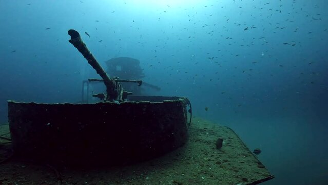 Under water film of the bridge of the ship wreck HTMS Sattakut at Ko Tao island - Frontal view of large gun - Thailand