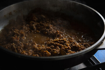 bolognese sauce in aluminum pot