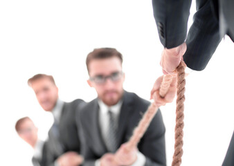 image is blurred.the tug of war between business people.