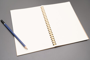 Notebook with a pencil. open spiral blank notebook with pencil on white desk background