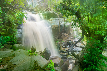 Beautiful Bamni waterfall having full streams of water flowing downhill amongst stones , duriing...