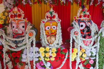 Idols of God Jagannath, Balaram and Goddess Suvadra. Lord Jagannath is being worshipped with...
