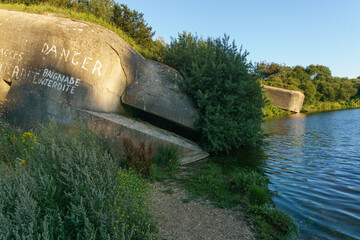 Sunken german bunker on lake le Fartz in golden sunlight at evening, Wissant, France
