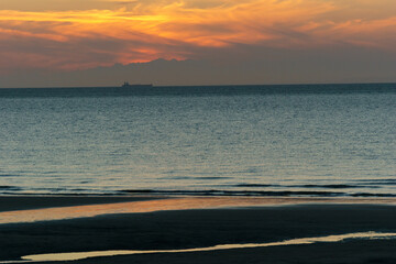 beautiful twilight after sunset on the french opal coast at the north sea with distant ship,...