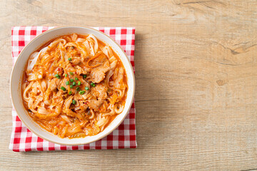 Korean udon ramen noodles with pork in kimchi soup
