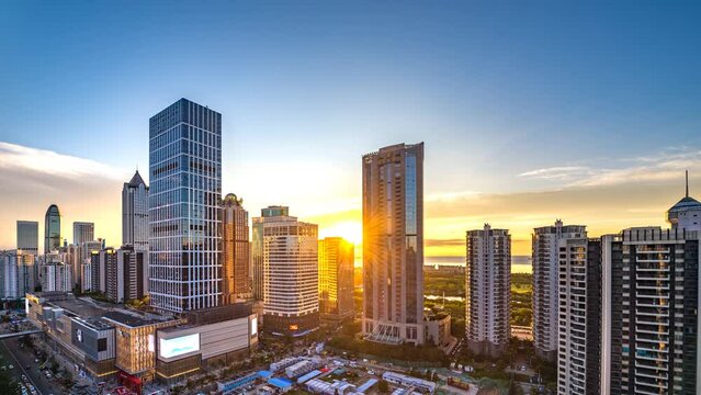 Timelapse of Urban Landscape in the Coastal Central Business District during Sunset, with Landmark Buildings Located along the Street, Haikou City , Hainan Province, China, Asia.