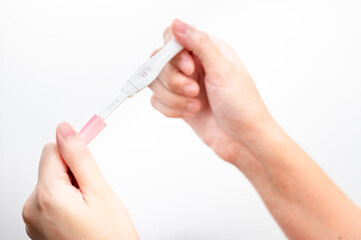  woman hand  holding pregnancy test. result female health problems and infertility. successful treatment IUI Intra &ndash; Uterine Insemination and ICSI. Pregnancy is not ready in adolescence..