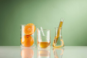 Front view of orange decorated with glassware and transparent podium in green background	