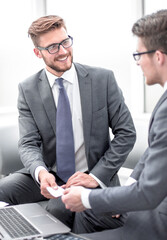 businessman gives the client a business card