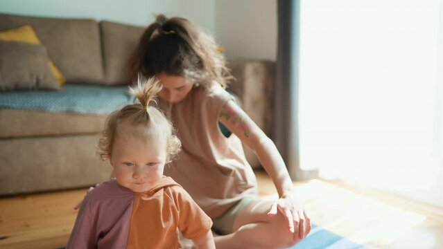 Funny Asian Family Young Healthy Mom Teaching Cute Little Kid Daughter Meditate Together Sit Floor At Home, Calm Mindful Japanese Mother And Child Girl Do Yoga Exercise Relax Together In Lotus Pose