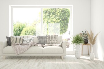 White living room with sofa and summer landscape in window. Scandinavian interior design. 3D illustration