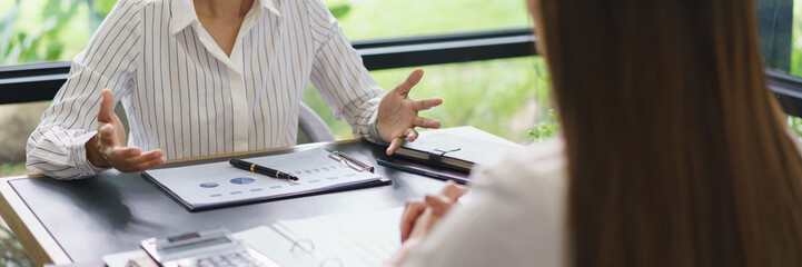 Coworker business concept, Businesswoman discussing and explaining about new project with colleague