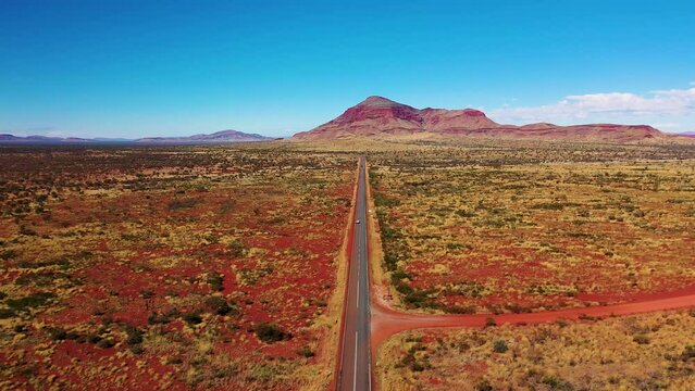 Aerial footage of a car driving twoards Mt Robinson in Karijini national park, Western Australia