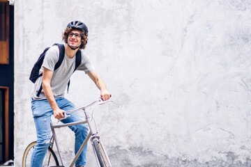 Portrait of casual hipster handsome businessman with backpack looking forward while commuting...