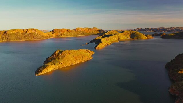 Aerial pushing in video of beautiful sunset and crocodile rock in Lake Argyle, Kimberley, Westerm Australia	