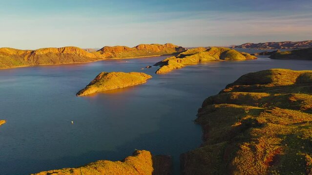 Aerial footage of beautiful sunset and crocodile rock in Lake Argyle, Kimberley, Westerm Australia