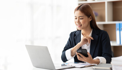 Portrait of confident businesswoman at workplace, smiling woman employee sitting behind laptop.