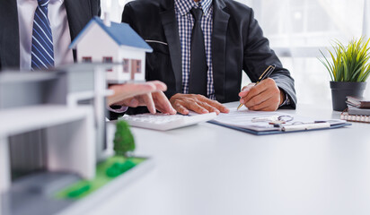 Real estate broker agent presenting and consult to customer to decision making sign insurance form agreement, buy and sell home model, concerning mortgage loan offer for and house insurance