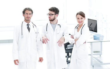 Male surgeon with nurse examining x-ray report