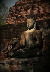 An ancient Buddha image in the Sukhothai period used as a background image.