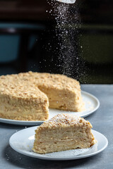 pieces of cake Napoleon on plate, multi layered cake with pastry cream, vertical image. top view