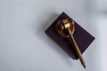 Judge gavel with books on white wooden table