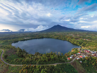 A lake with a mountain background arround the cinnamon plantation in the centre of sumatra highland