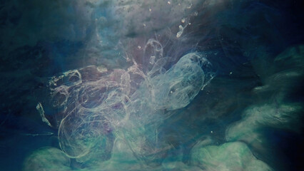 Fototapeta na wymiar Ink floating in water. Color mist cloud. Underwater explosion. Green blue beige glowing smoke haze flow abstract art copy space background.