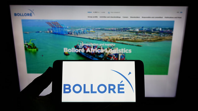 Stuttgart, Germany - 02-06-2022: Person holding smartphone with logo of French conglomerate company Bollore SE on screen in front of website. Focus on phone display.