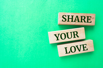 Share your love words on wooden blocks on green background.