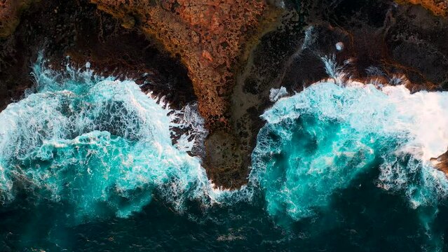 Aerial birds eye view of waves crushing on the rocks, quobba station, red bluff in Western Australia 