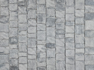 Granite cobblestone background. Paving stone texture. Pavement.