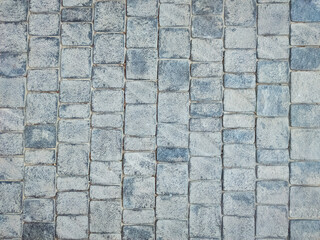 Granite cobblestone background. Paving stone texture. Pavement.