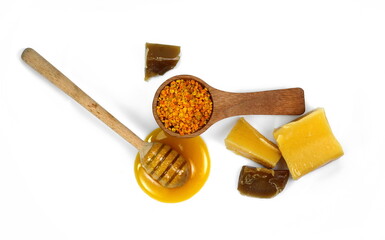 Bee products. Honey with dipper, bee pollen and natural wax isolated on white background. 