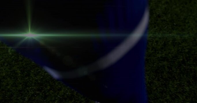 Animation of light trails over football player kicking ball at stadium