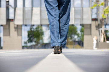 Woman feet walking stepped on a white line moving forward for success.