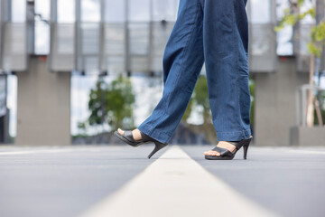 Moving forward, New start and Success Concept - Woman's feet in black high-heeled shoes stepping...