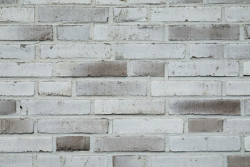 White brick wall background with cracked and rough surface of the stones, no person 