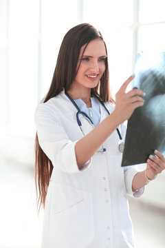 close up.smiling woman doctor looking x-ray of the patient