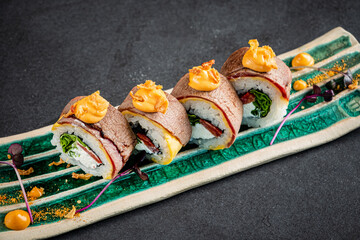 creative sushi on the black stone