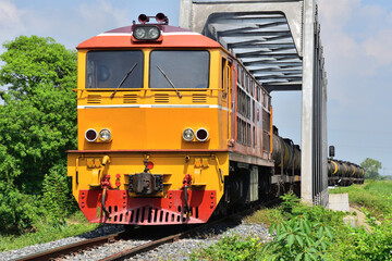 Obraz premium Thai tanker freight-train by diesel locomotive on the railway.