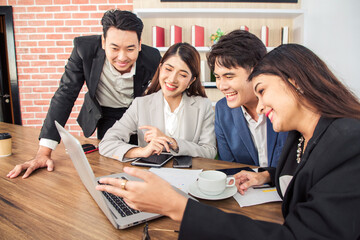 Young asian business people looking at screen during video conference in office