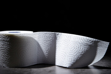 roll of tissue paper on a dark background