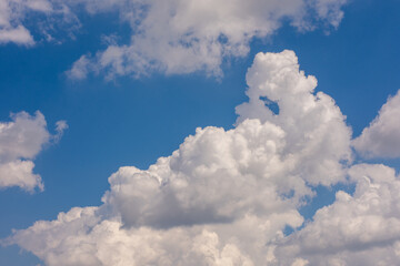 Naklejka na ściany i meble Beautiful blue sky and white fluffy clouds