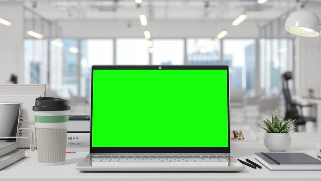 Mockup Green Screen Laptop On Table With Blurred Office In Background