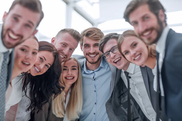 close up.a team of young business people looking at the camera.