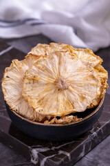 Dried pineapple slices. Sliced dried pineapple on dark background. Sun-dried fruit. close up